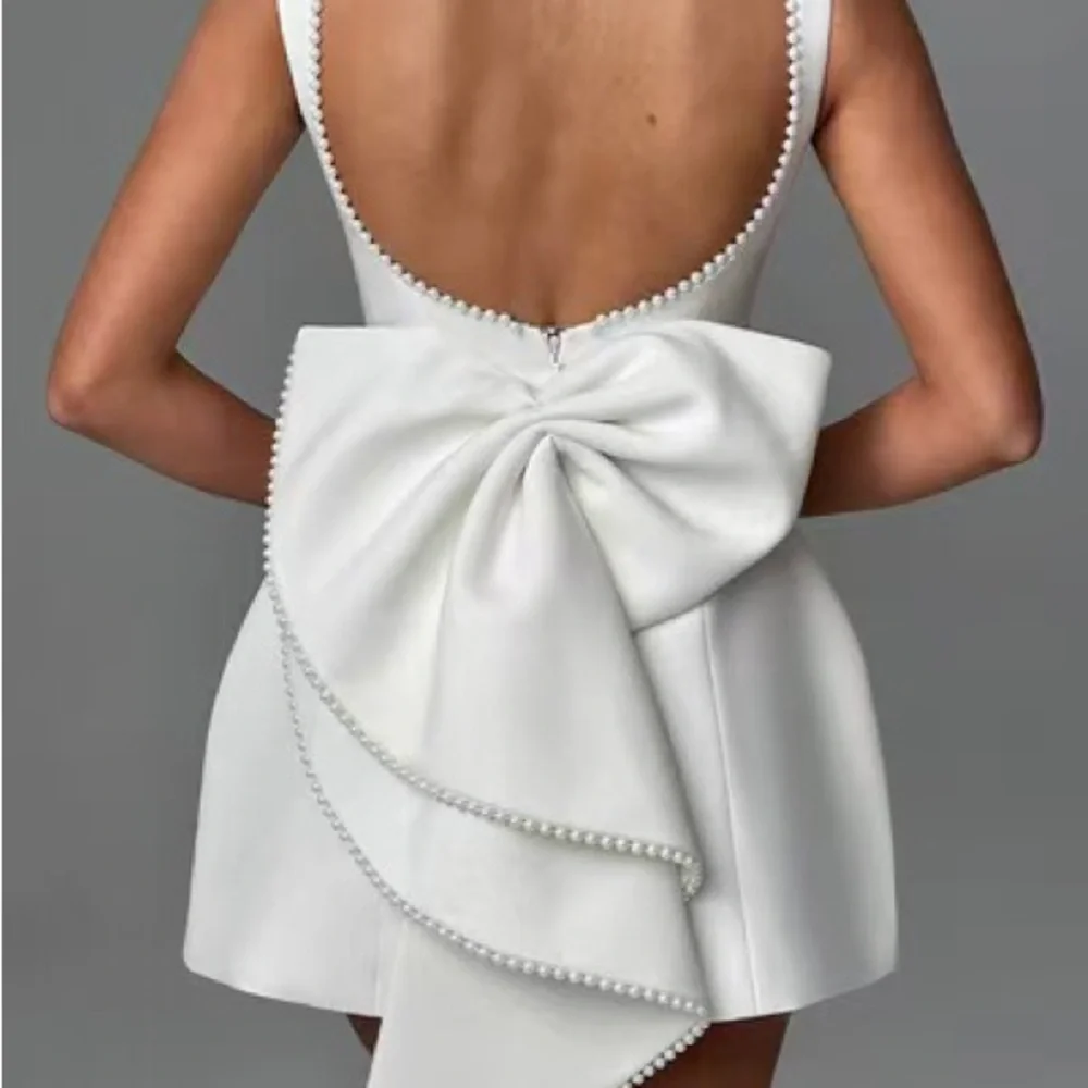 Elegant White Pearl-Trim Backbow Mini Dress